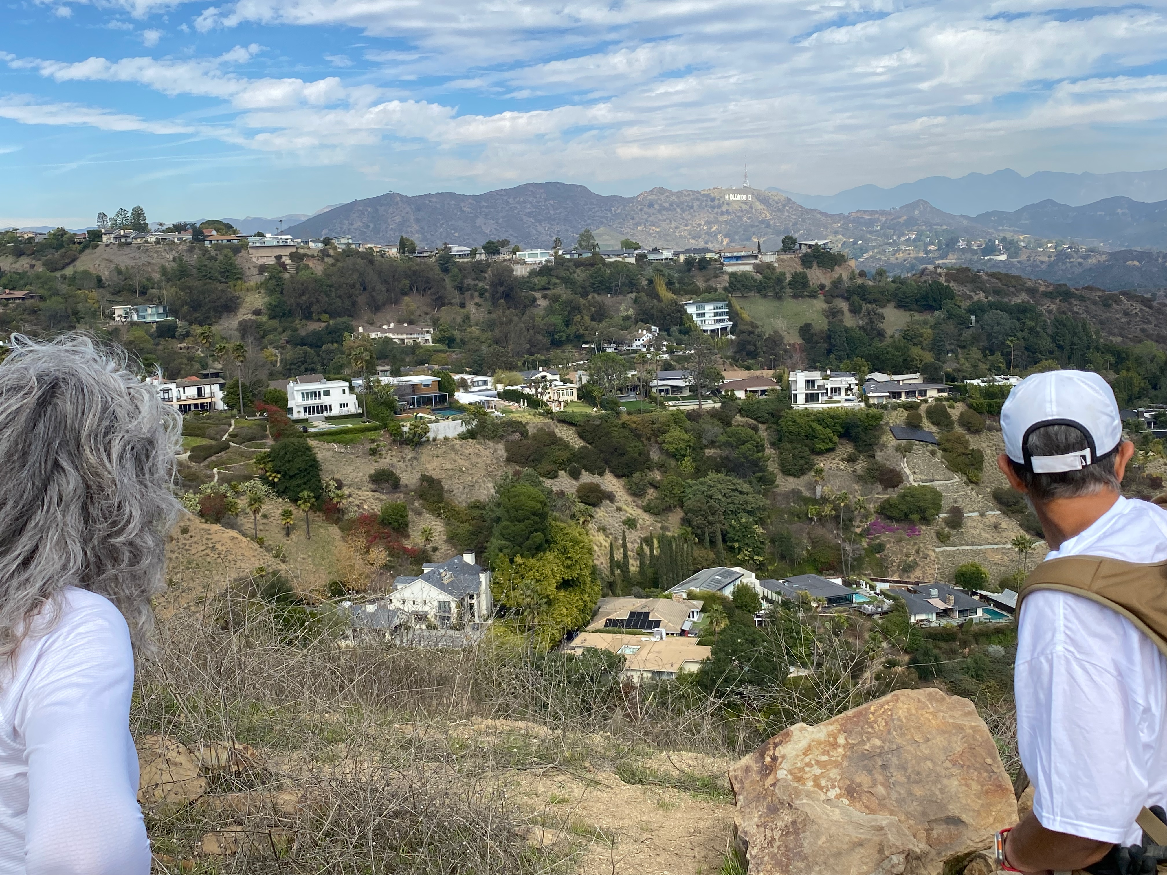 View from Runyon Canyon hill with two friends looking towards Hollywood sign