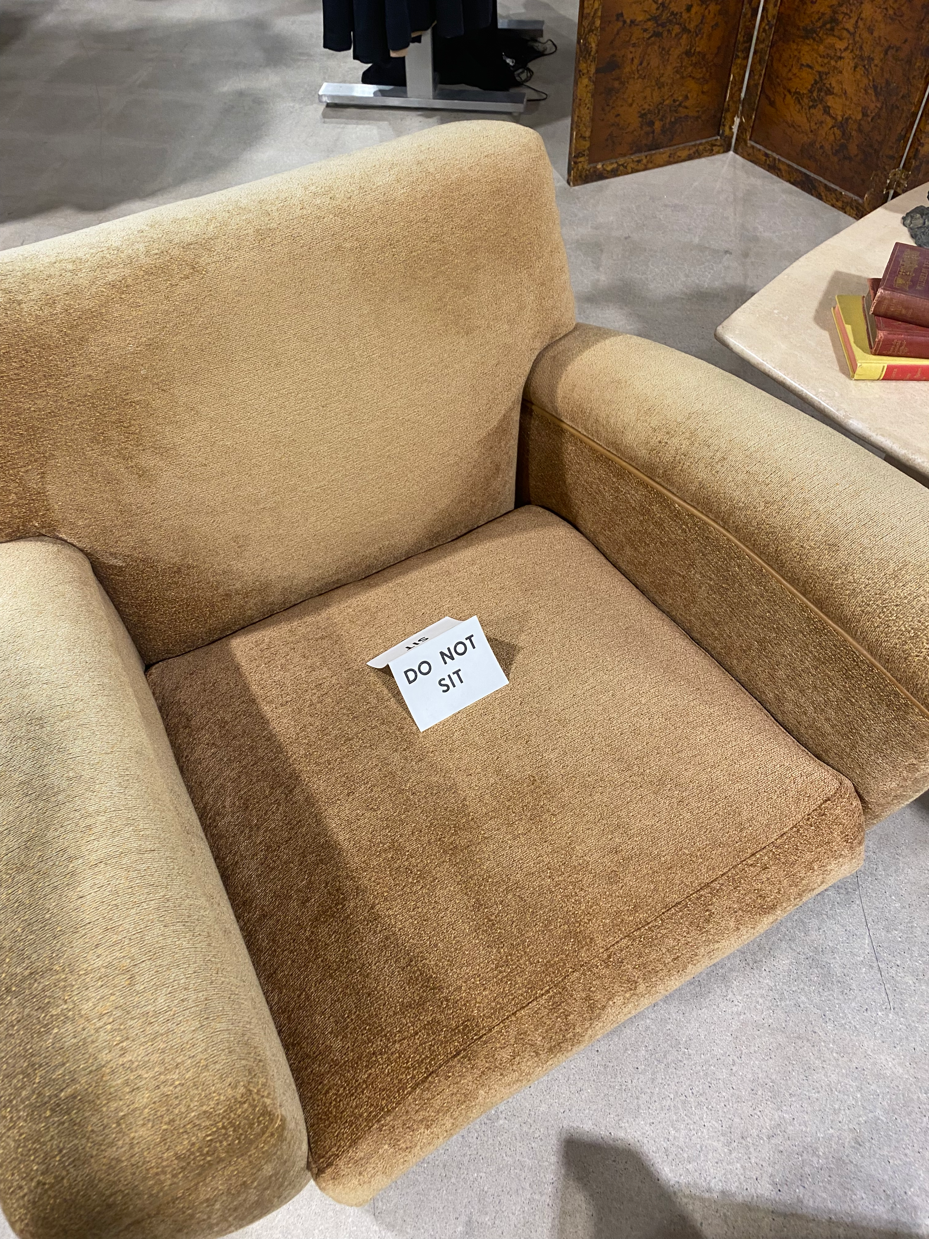 a chair with a sign on it saying Don't Sit