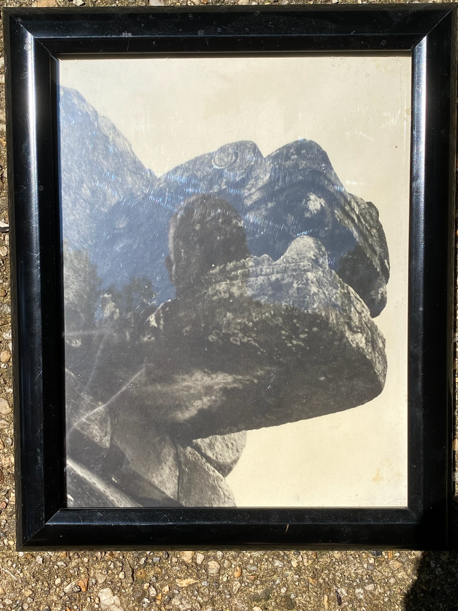 picture of a balck and white picture of a monster's head sculpture on a Mayan structure