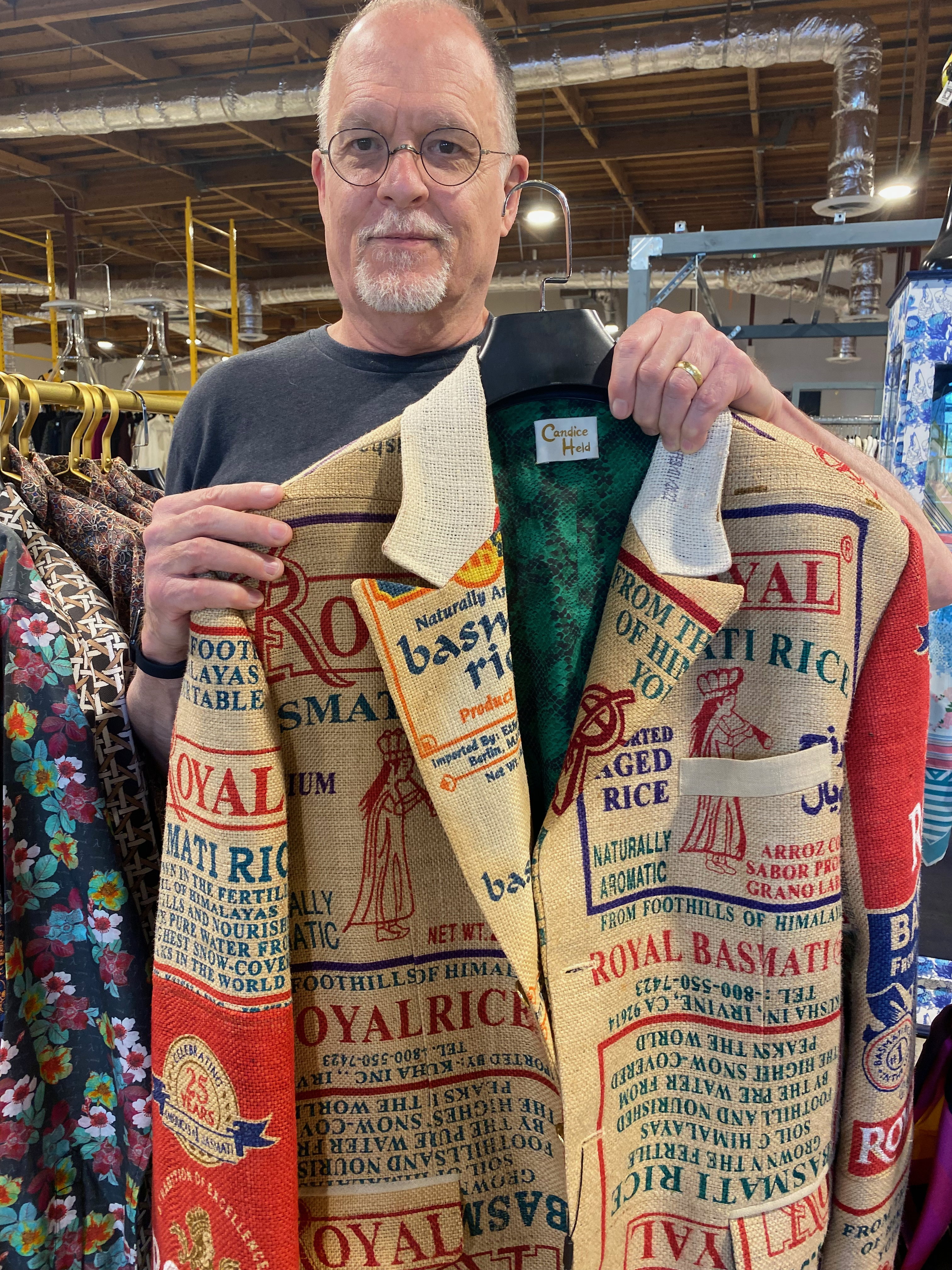 me holding up a jacket made from rice sacks