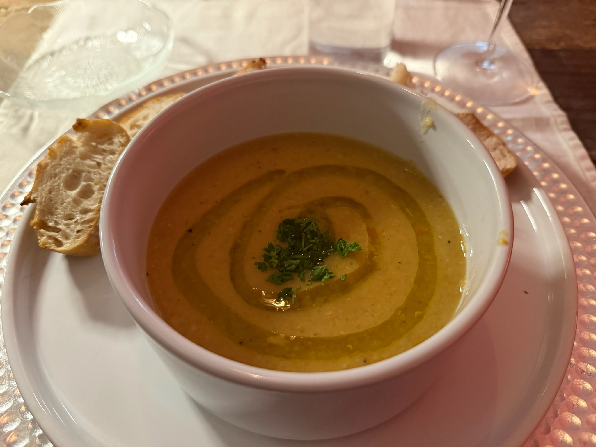 a bowl of soup with seasoning applied artistically